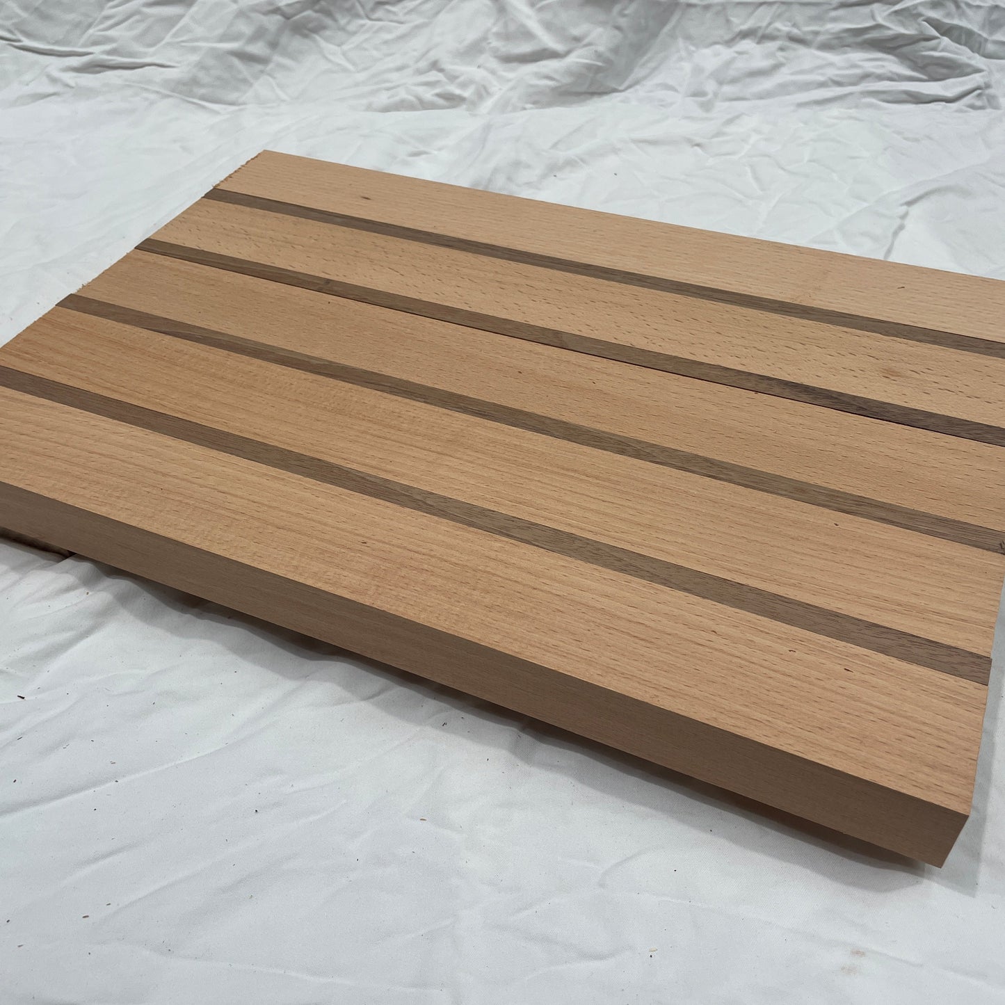 Wooden cutting board with a striped pattern on a white background