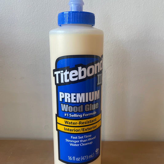 Titebond premium wood glue bottle on a light gray background