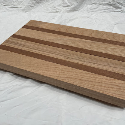 Wooden cutting board with striped pattern on a white background