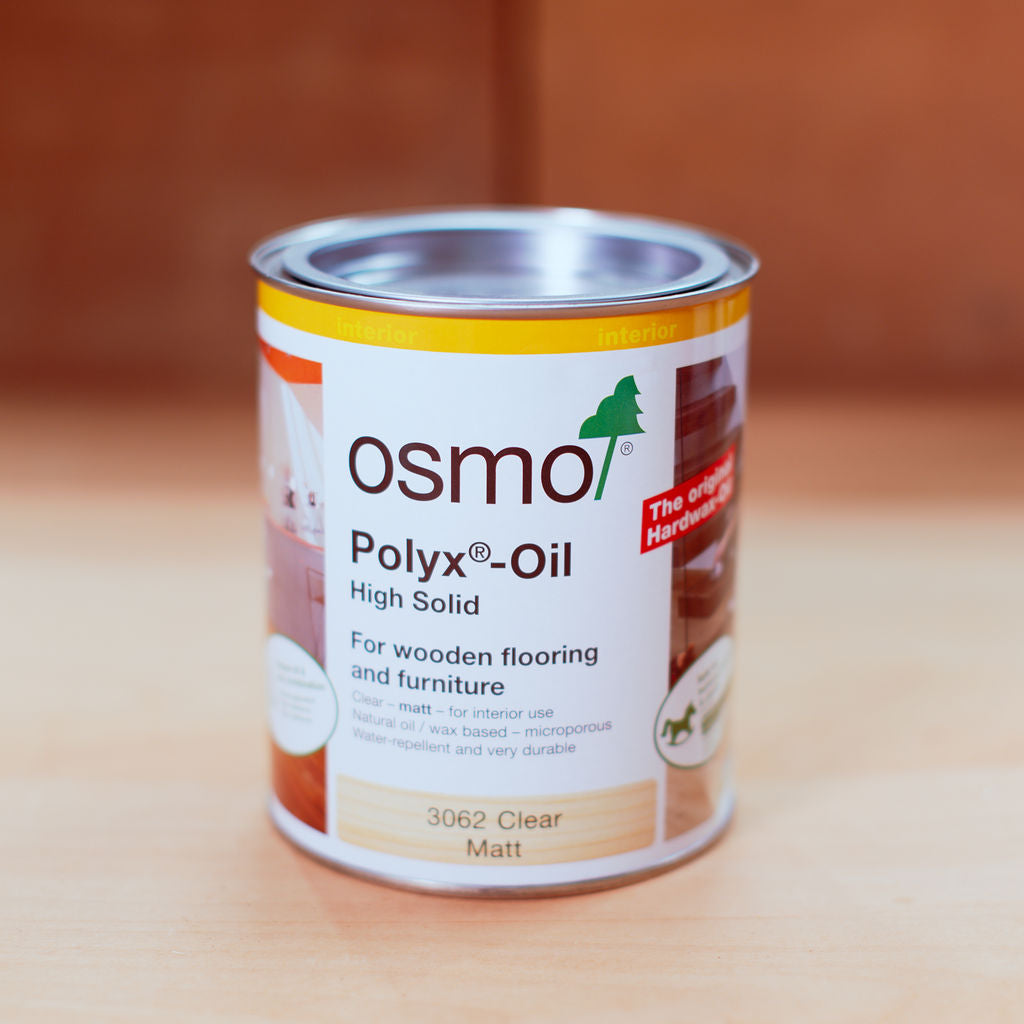 Tin of Osmo Polyx oil clear matt finish on a brown background